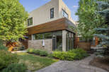 Discover modern living in this stunning home featuring a striking facade with a blend of stucco and warm wood accents.