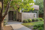 Discover modern living with this stunning home featuring a sleek facade of wood and stone.