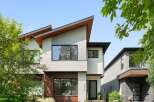 Discover modern architectural brilliance with this stunning home featuring a unique, asymmetrical roofline and a striking blend of stucco and brick exterior.
