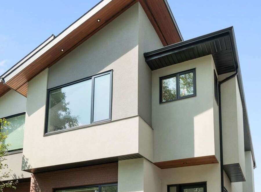 Experience modern living in this stunning home featuring a sleek stucco exterior and striking architectural lines.