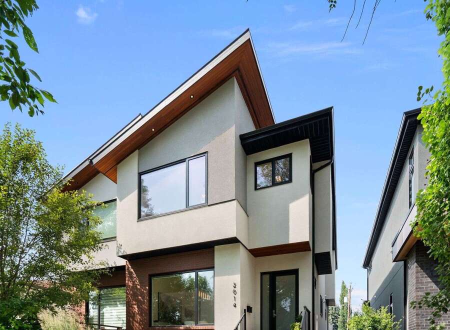 Discover modern luxury in this stunning architectural gem, featuring a striking asymmetrical roofline and expansive windows that flood the interior with natural light.
