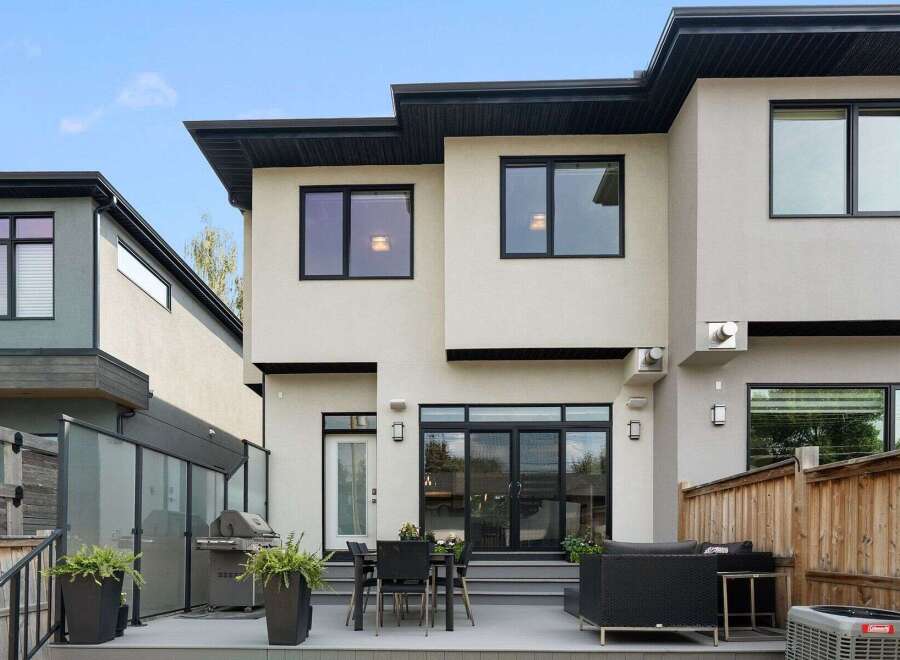 Experience modern living in this stunning home featuring a sleek exterior and a spacious backyard oasis.