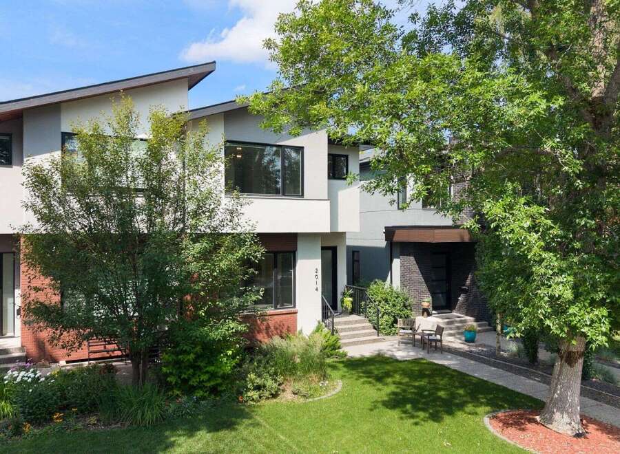 Discover modern living in this stunning multi-level townhouse featuring a striking architectural design with a unique angled roofline.