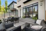 Experience seamless indoor-outdoor living with this modern backyard oasis, featuring a spacious deck perfect for entertaining.