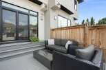 Enjoy outdoor living on this modern deck featuring comfortable seating and a sleek fire pit.