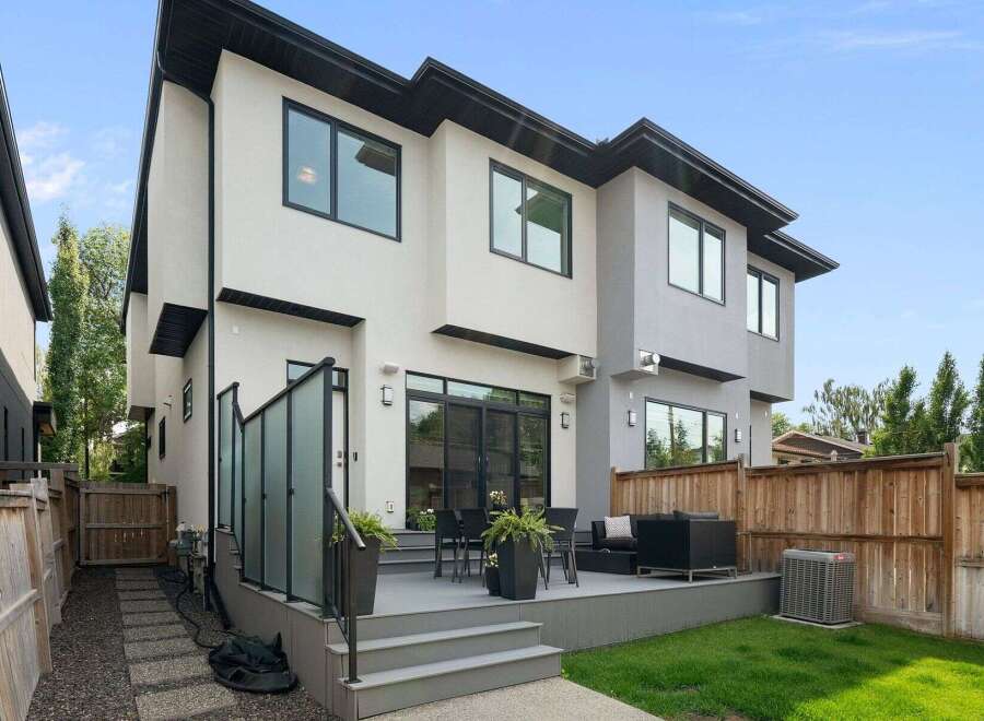 Experience modern luxury in this stunning home featuring a spacious backyard deck perfect for entertaining.