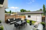 Enjoy outdoor living at its finest with this spacious deck featuring a modern dining set and comfortable lounge area, perfect for entertaining guests.