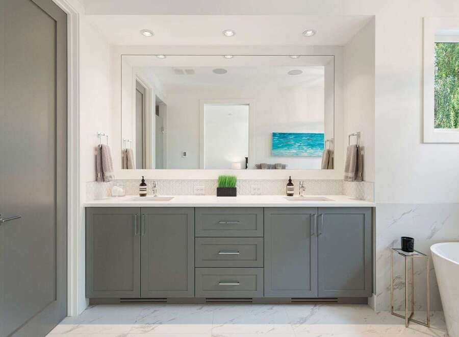 Experience luxury in this modern bathroom featuring a spacious double vanity with sleek gray cabinetry and a large, illuminated mirror.