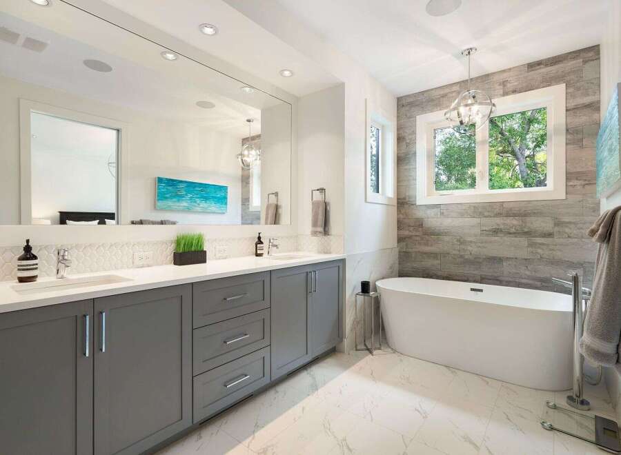 Experience luxury in this stunning modern bathroom, featuring a sleek grey double vanity with ample storage and a pristine white countertop.