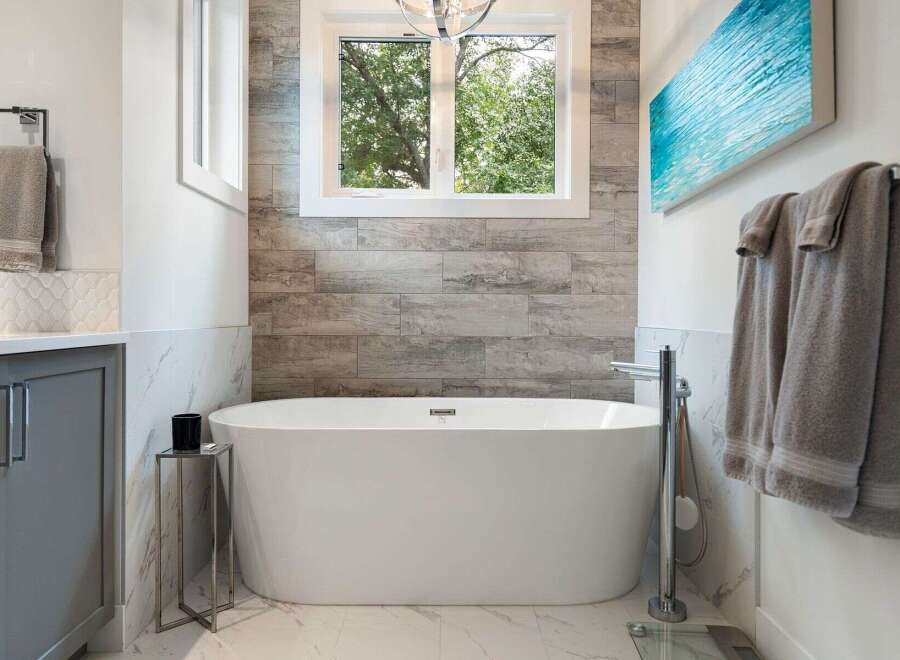 Experience luxury in this stunning bathroom featuring a freestanding soaking tub, perfect for unwinding after a long day.