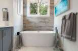 Experience luxury in this stunning bathroom featuring a freestanding soaking tub, perfect for unwinding after a long day.