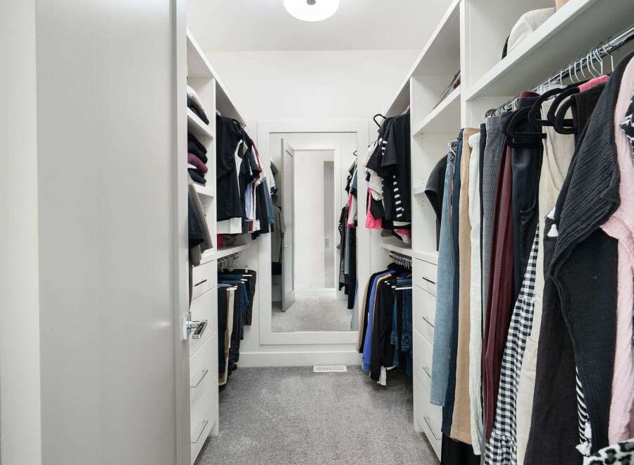 Step into this impeccably organized walk-in closet, designed for ultimate functionality and style.