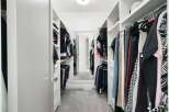 Step into this impeccably organized walk-in closet, designed for ultimate functionality and style.