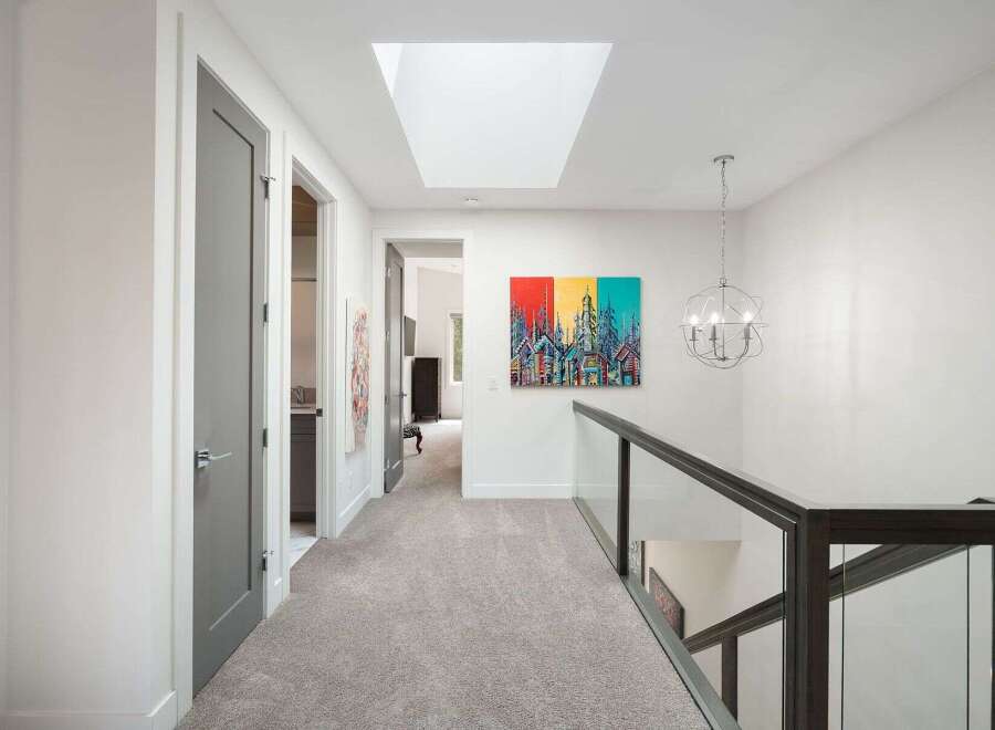 Experience modern living in this stunning hallway featuring a sleek skylight that floods the space with natural light.
