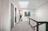 Experience modern living in this stunning hallway featuring a sleek skylight that floods the space with natural light.