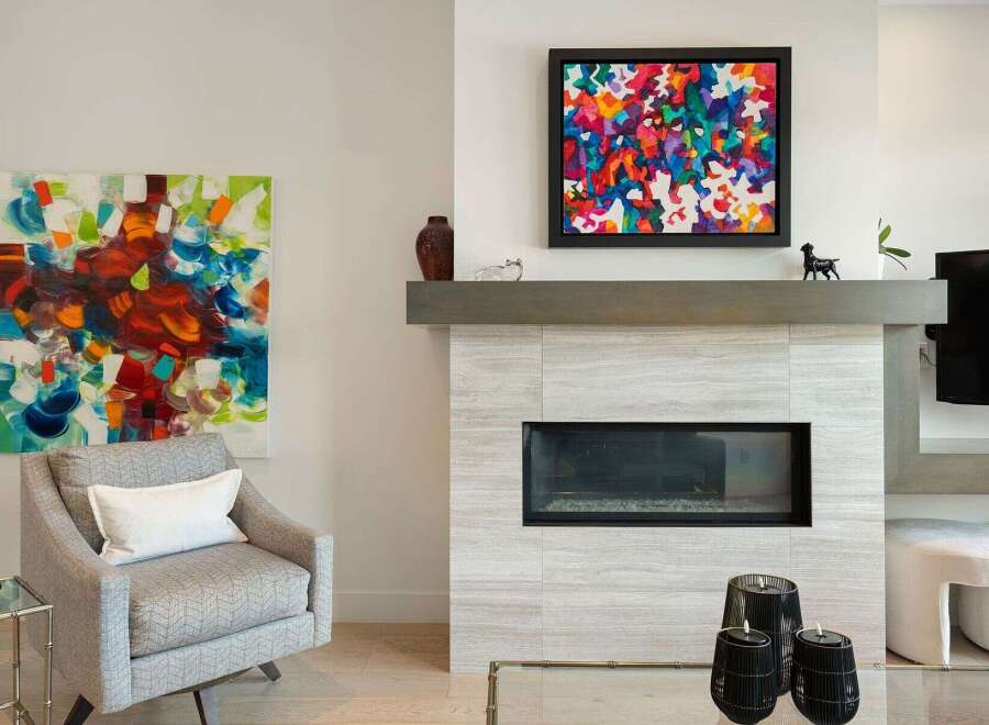 Experience modern living with this stunning living room featuring a sleek fireplace and vibrant abstract art.