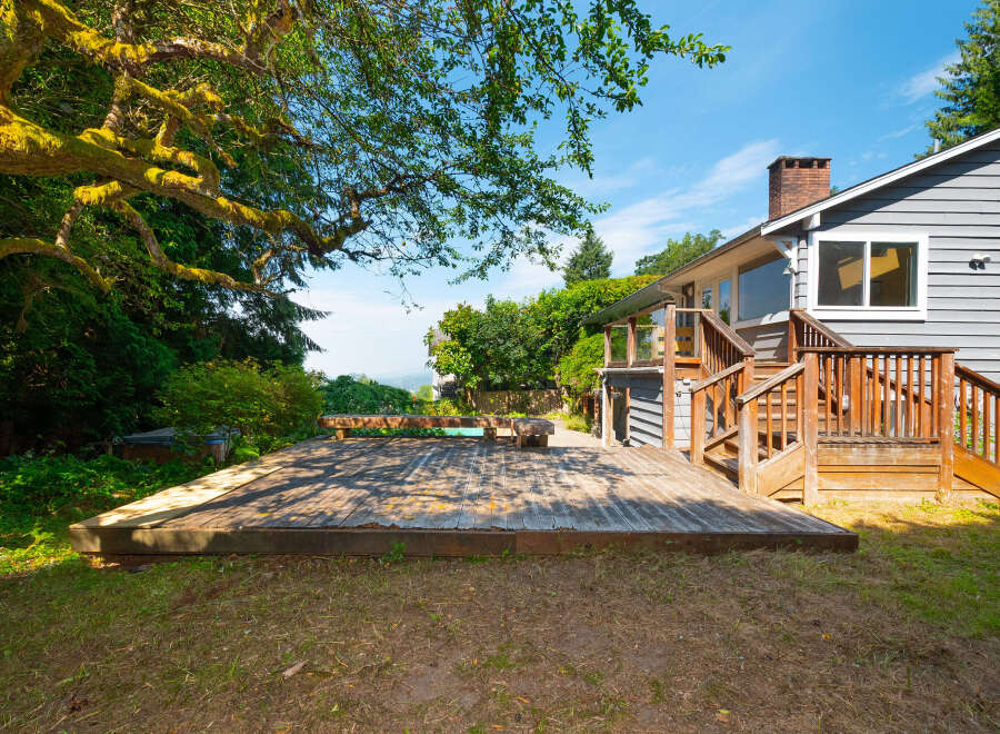 Enjoy outdoor living with this spacious wooden deck, perfect for entertaining or relaxing.
