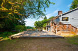 Enjoy outdoor living with this spacious wooden deck, perfect for entertaining or relaxing.