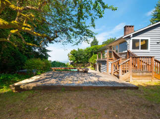 Enjoy outdoor living with this spacious wooden deck, perfect for entertaining or relaxing.