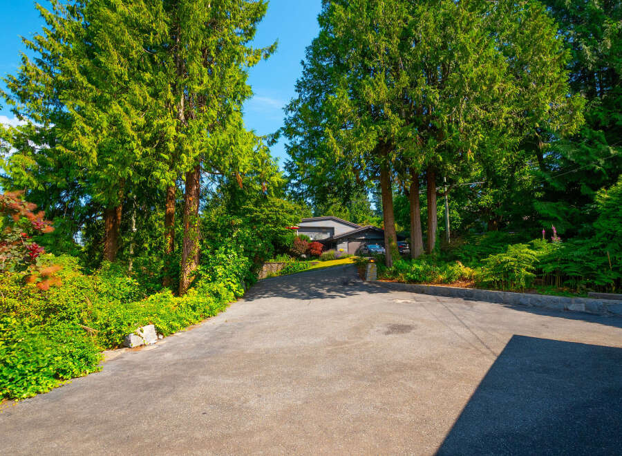 Nestled amidst lush greenery and mature trees, this property offers a serene and private retreat.