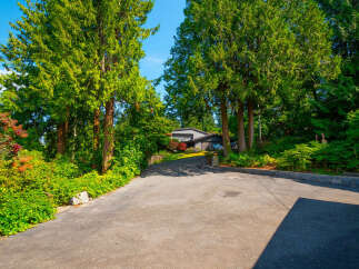Nestled amidst lush greenery and mature trees, this property offers a serene and private retreat.