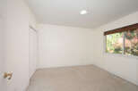 This empty room features neutral-toned carpeting and walls, creating a blank canvas for your personal style.