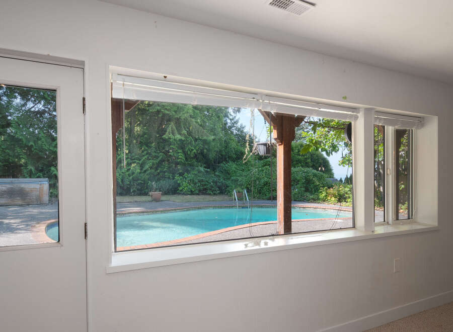 Enjoy your own private oasis with this stunning backyard featuring a sparkling swimming pool and a relaxing hot tub.