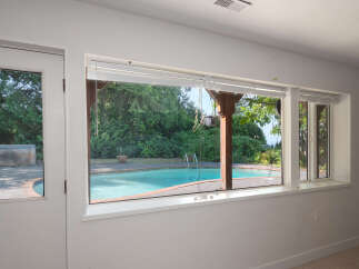 Enjoy your own private oasis with this stunning backyard featuring a sparkling swimming pool and a relaxing hot tub.