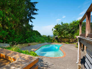 Escape to your private oasis with this stunning kidney-shaped swimming pool, perfect for summer relaxation and entertaining.
