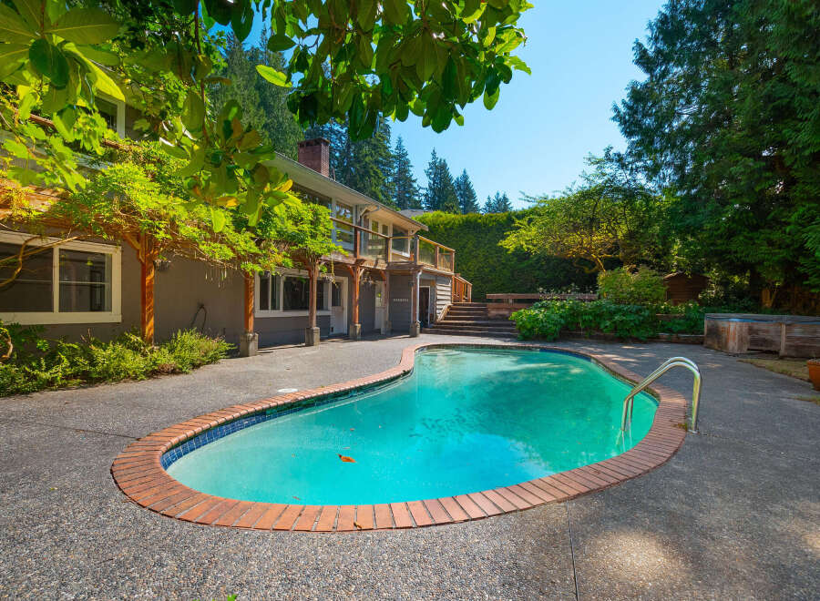 Escape to your private oasis with this stunning backyard featuring a sparkling kidney-shaped pool, perfect for summer relaxation and entertaining.