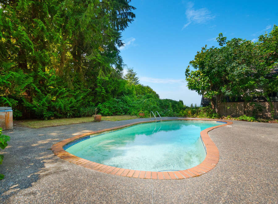 Escape to your private oasis with this stunning backyard featuring a sparkling in-ground swimming pool, perfect for hot summer days.