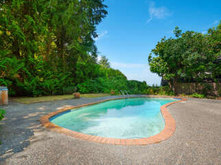 Escape to your private oasis with this stunning backyard featuring a sparkling in-ground swimming pool, perfect for hot summer days.