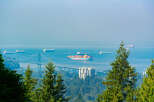Experience breathtaking panoramic views from this prime real estate location, overlooking the Lions Gate Bridge and the bustling Vancouver harbor.