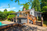 Enjoy outdoor living with this charming home featuring a spacious wooden deck and a sparkling swimming pool, perfect for entertaining or relaxing.