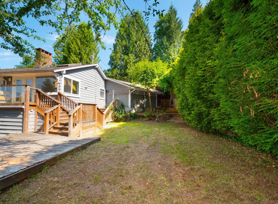 Enjoy outdoor living with this spacious deck and backyard, perfect for entertaining or relaxing.