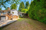 Enjoy outdoor living with this spacious deck and backyard, perfect for entertaining or relaxing.