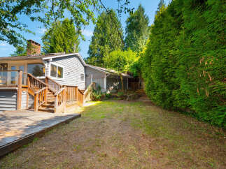 Enjoy outdoor living with this spacious deck and backyard, perfect for entertaining or relaxing.