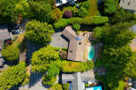 Discover this stunning aerial view showcasing a luxurious property with a private swimming pool and expansive green spaces.