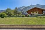 Nestled against a backdrop of majestic mountains, this charming wooden chalet offers a serene retreat.