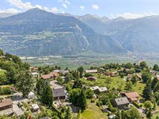 Nestled amidst rolling green hills and offering breathtaking panoramic views of the majestic mountains and valley below, this charming property presents an idyllic retreat.