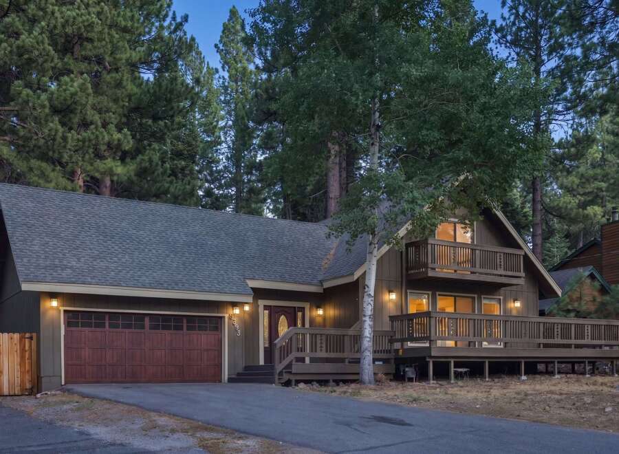 Nestled among tall pine trees, this charming home offers a serene mountain retreat.