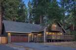 Nestled among tall pine trees, this charming home offers a serene mountain retreat.