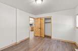 Discover this charming bedroom featuring a spacious closet with elegant wooden sliding doors, perfect for maximizing space.
