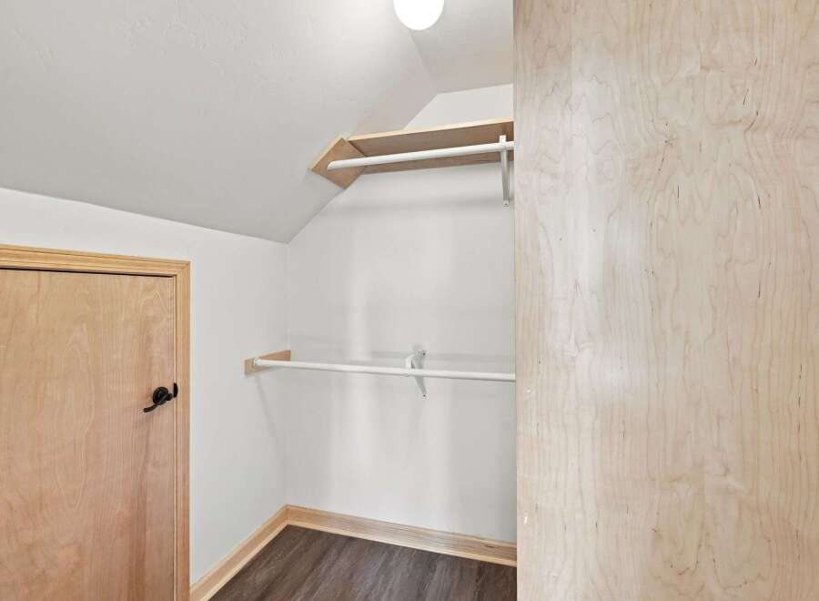Discover ample storage in this charming closet featuring a built-in shelving unit and a sturdy hanging rod, perfect for organizing your wardrobe.