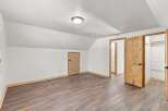 Discover this charming bedroom featuring a vaulted ceiling and a spacious walk-in closet, perfect for ample storage.