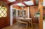 Experience cozy dining in this charming space featuring a rustic wooden dining table and bench, perfect for intimate meals.