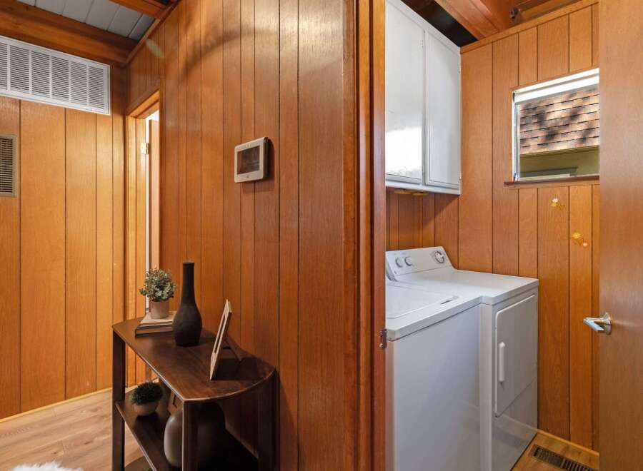 Discover a charming interior featuring warm wood paneling throughout, creating a cozy and inviting atmosphere.