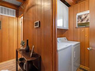 Discover a charming interior featuring warm wood paneling throughout, creating a cozy and inviting atmosphere.