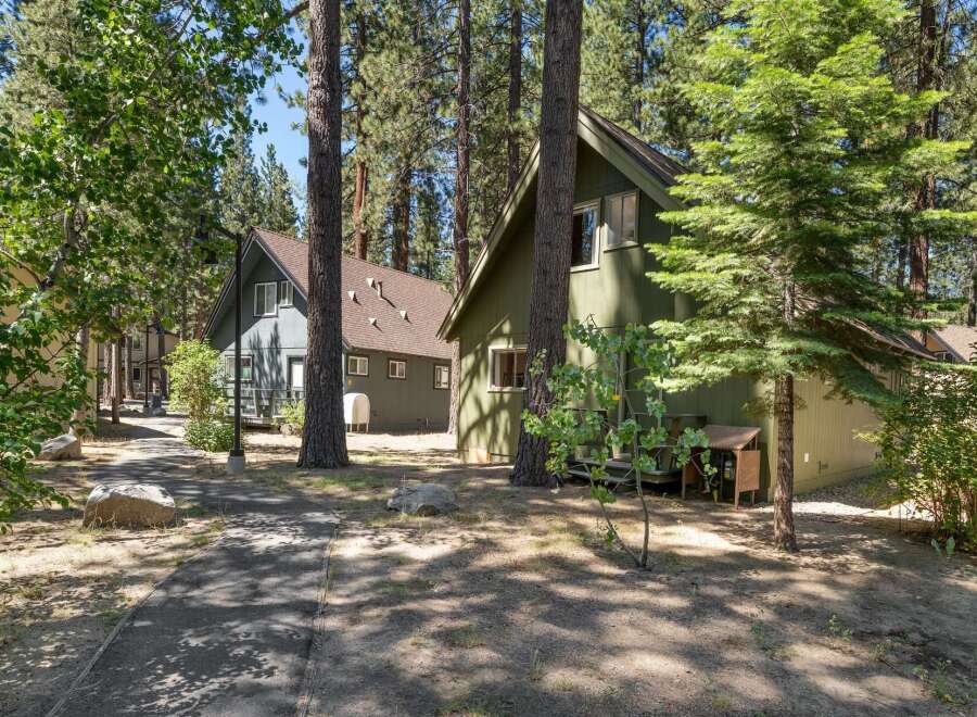Nestled among tall pine trees, this charming property features two distinct cabins, perfect for a getaway or rental income.