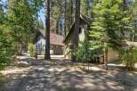 Nestled among tall pine trees, this charming property features two distinct cabins, perfect for a getaway or rental income.